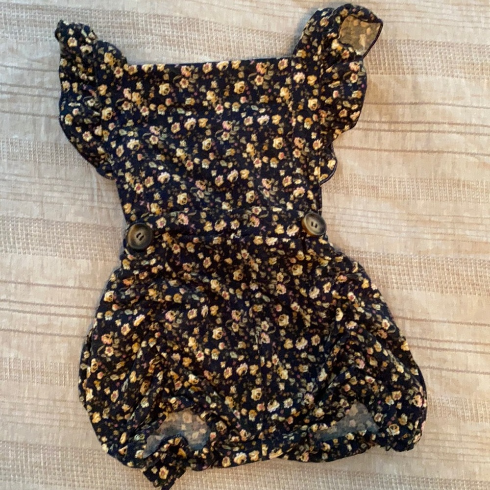 12 month romper. Navy with tan floral pattern. Adjustable straps.